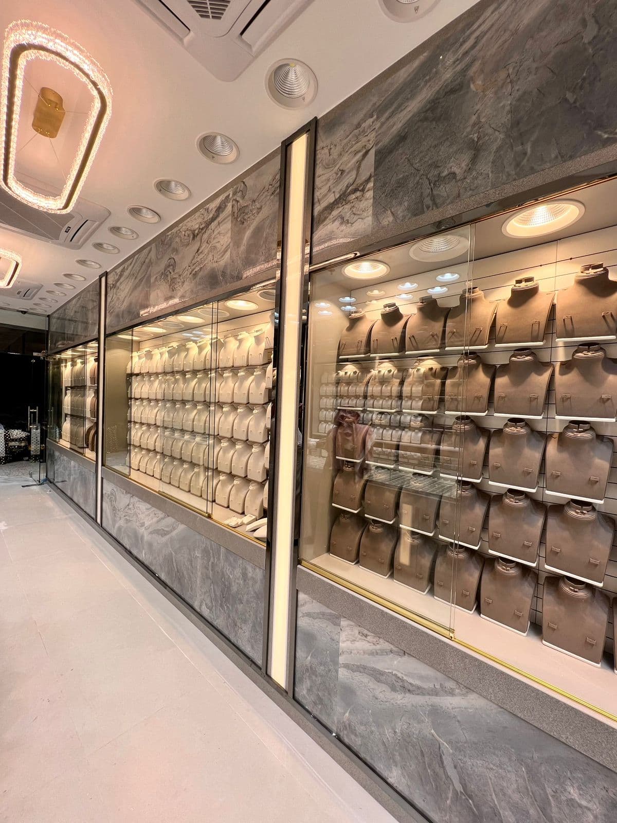 Gold shop interior fit-out with marble walls and glass display cases