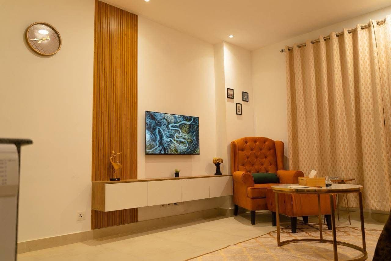 Living room with wall-mounted TV unit and armchair