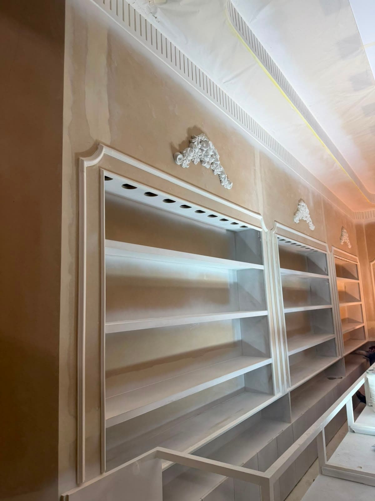 Ornate retail shop shelving under construction